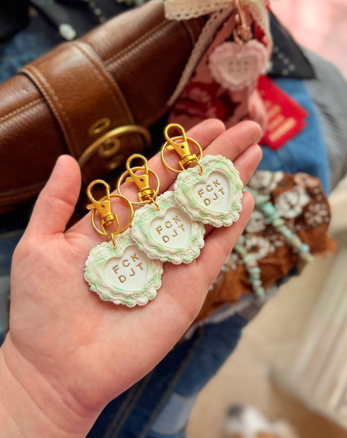 Handmade green FCK DJT protest heart keychains and anti Trump bag charms