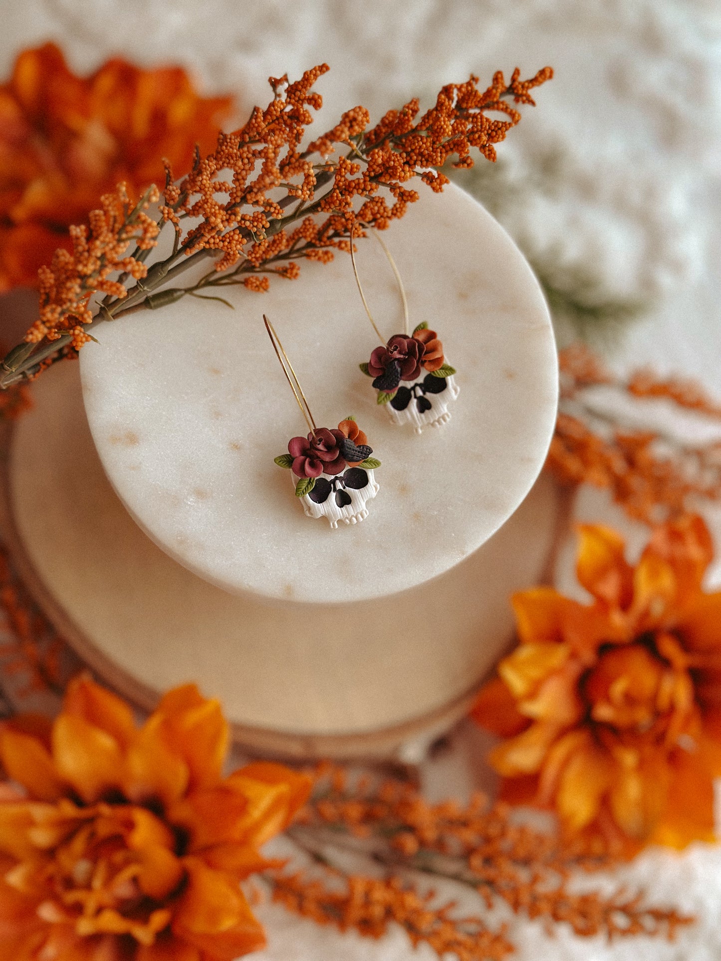 Autumn floral skull hoop polymer clay earrings skull with flower accents