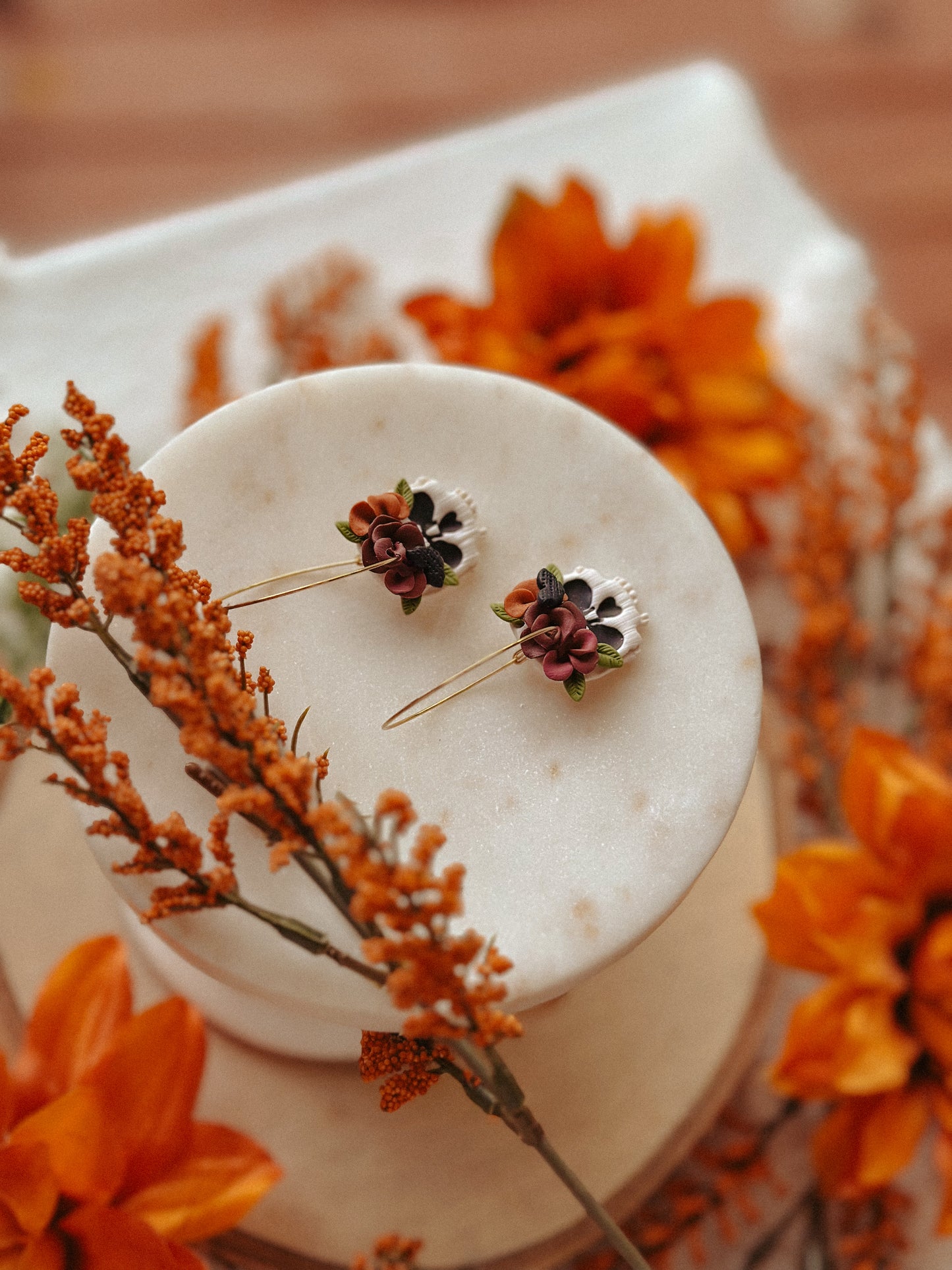 Autumn floral skull hoop polymer clay earrings skull with flower accents