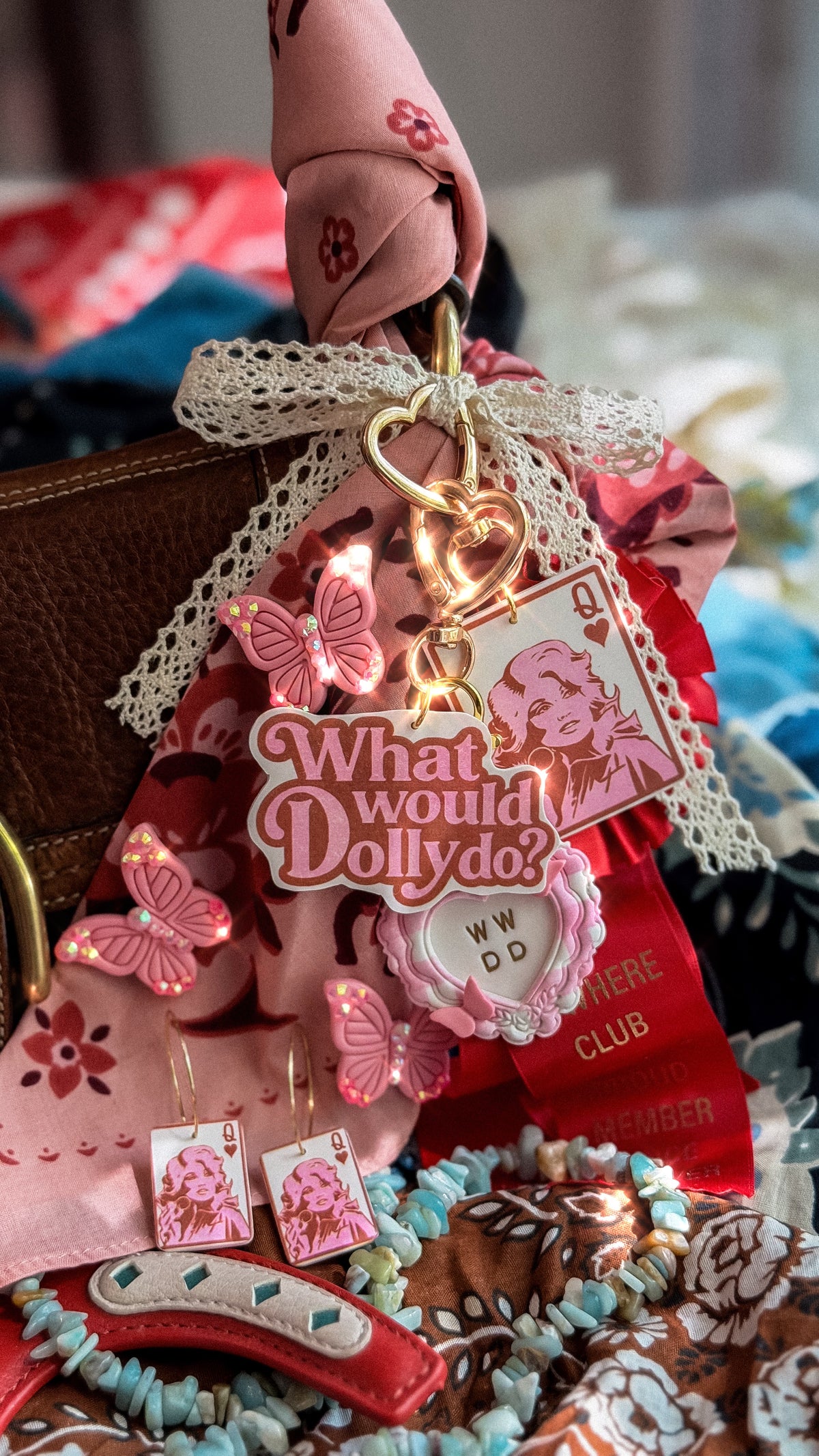 Queen Dolly bag charm styled with What Would Dolly Do charm, pink butterflies and matching Queen Dolly earrings