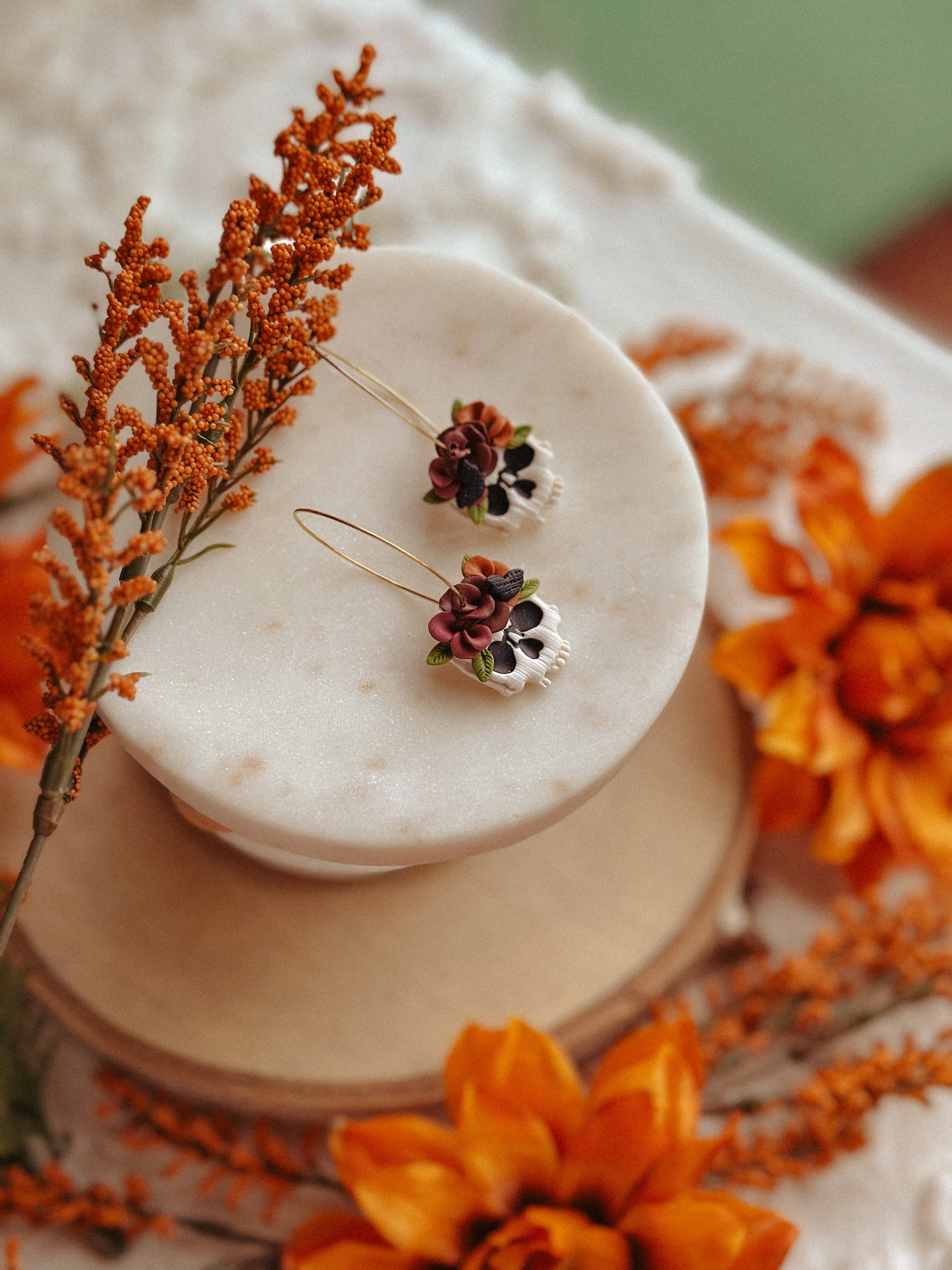 Autumn floral skull hoop polymer clay earrings skull with flower accents