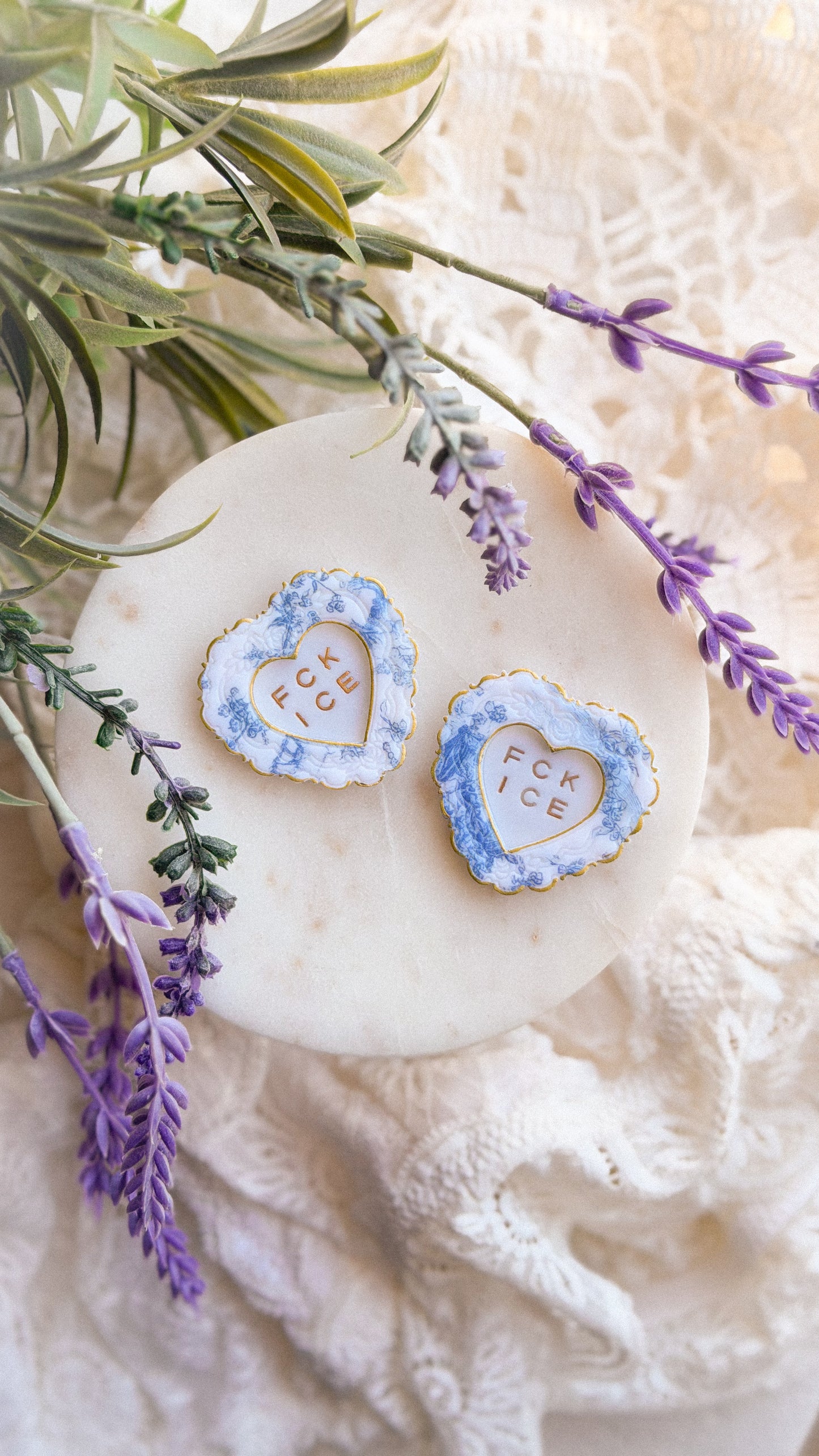 Styled shot of Chinoiserie FCK ICE Heart Magnet holding photos on a refrigerator door — playful handmade art magnet gift idea.