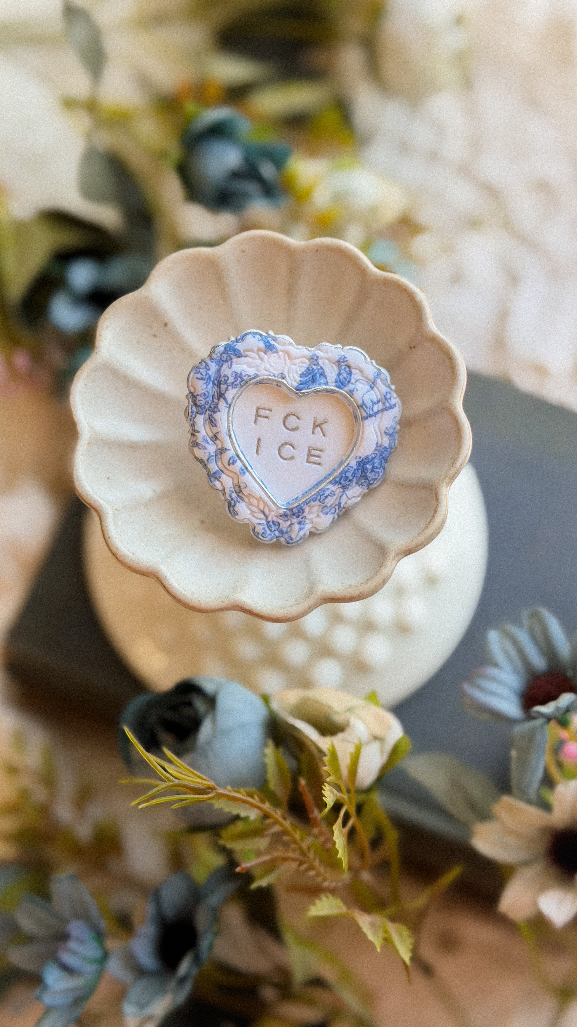Handmade FCK ICE chinoiserie heart frame brooch in silver with blue floral detail — polymer clay statement lapel pin for jackets bags and hats