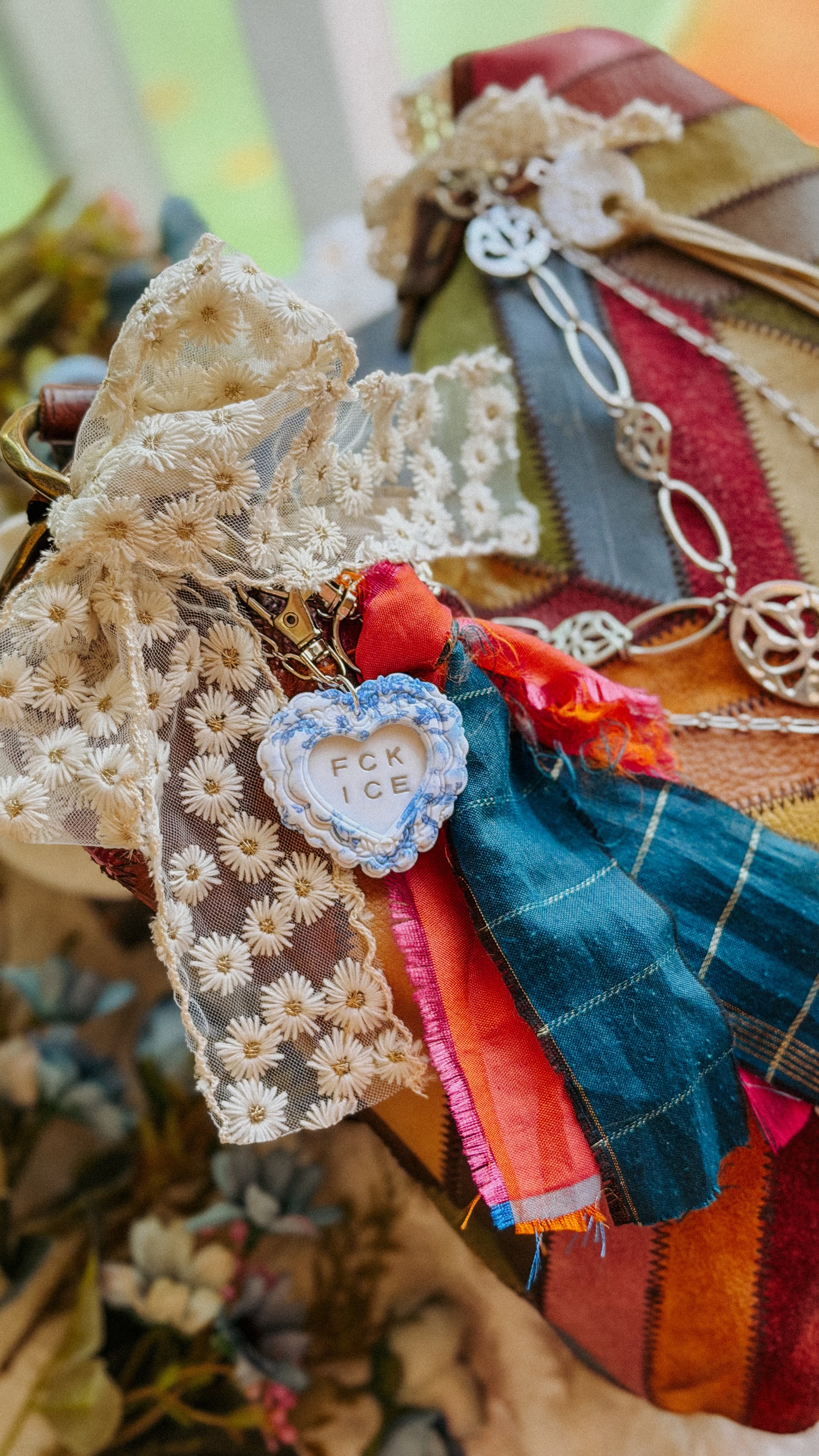 Detailed view of chinoiserie-inspired heart keychain with embossed lettering and silver-blue floral design — unique artisan keychain gift