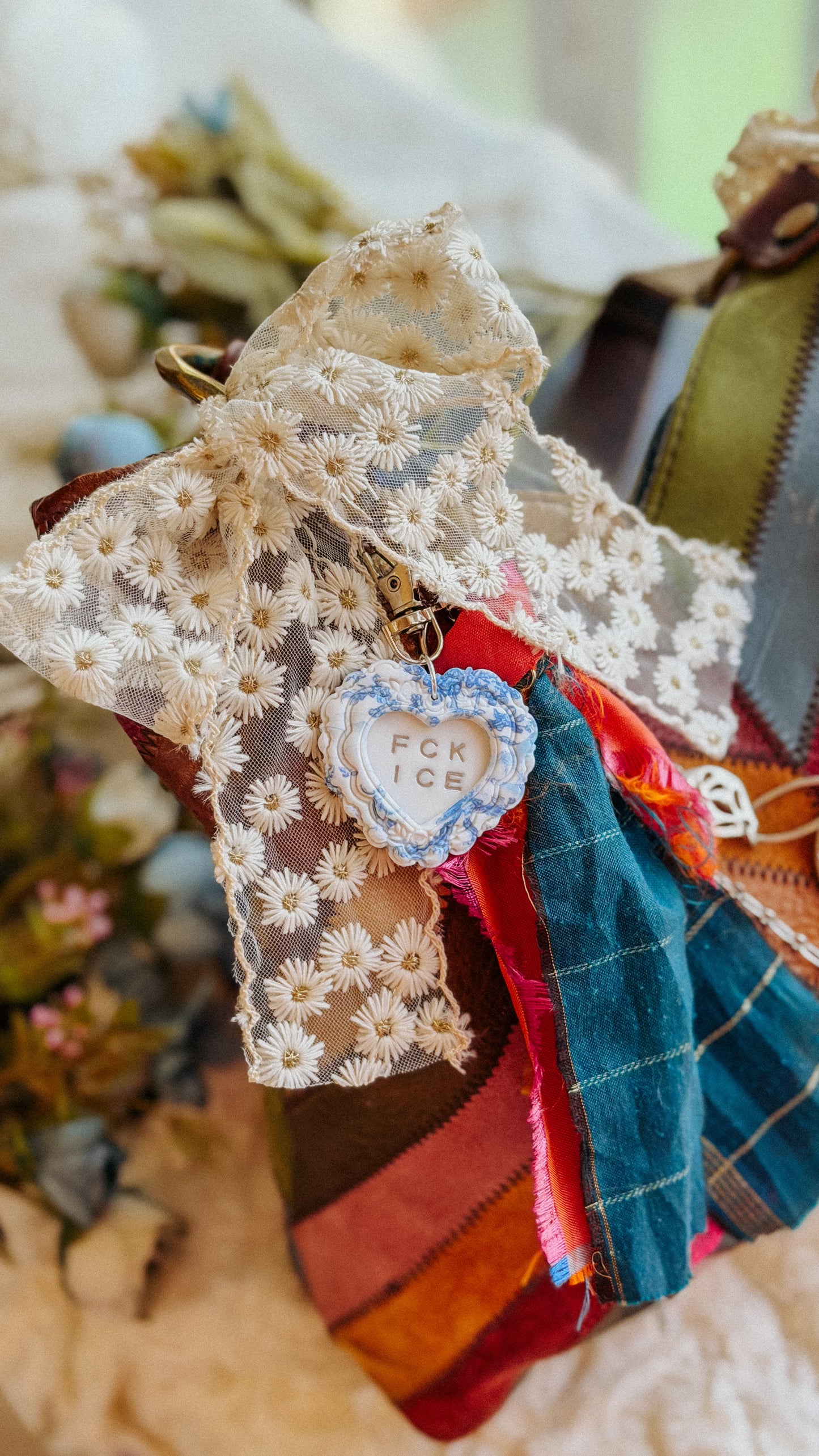 FCK ICE handmade polymer clay heart keychain styled as a bag charm on tote — bold statement accessory for keys, purse, or backpack.