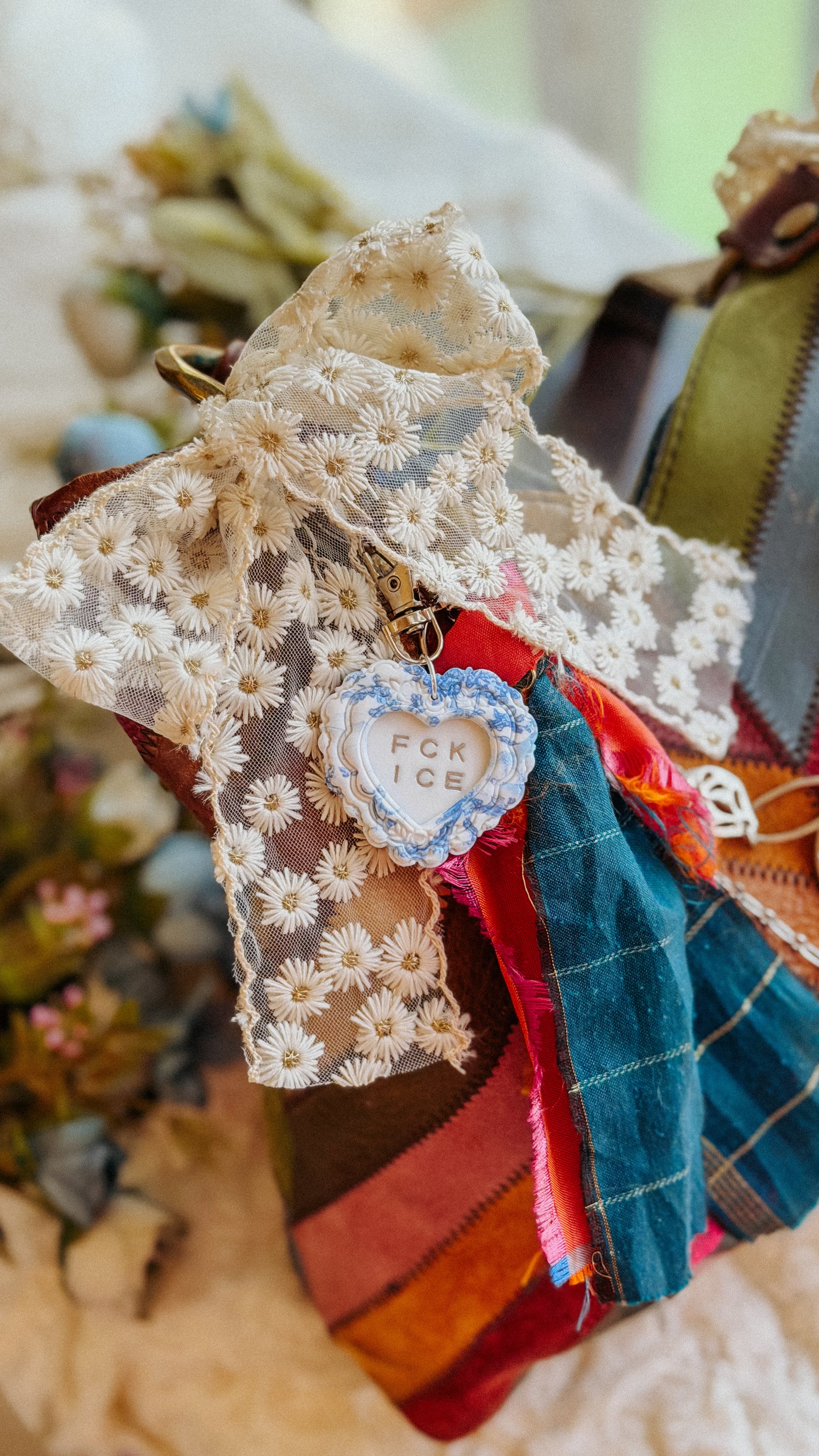 FCK ICE handmade polymer clay heart keychain styled as a bag charm on tote — bold statement accessory for keys, purse, or backpack.