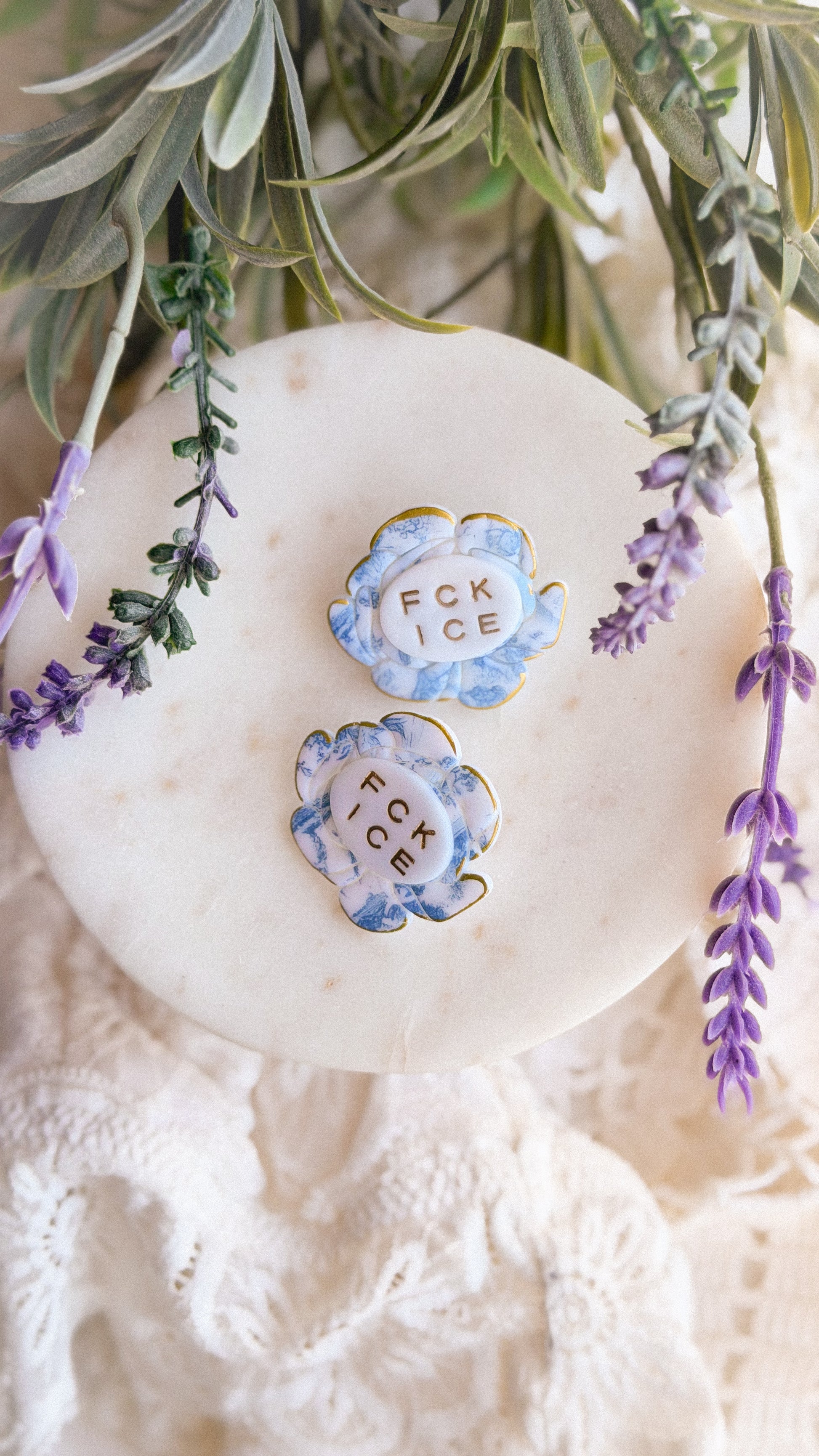 Styled shot of the handmade floral brooch pinned to a coat lapel, highlighting artistic texture and bold design.